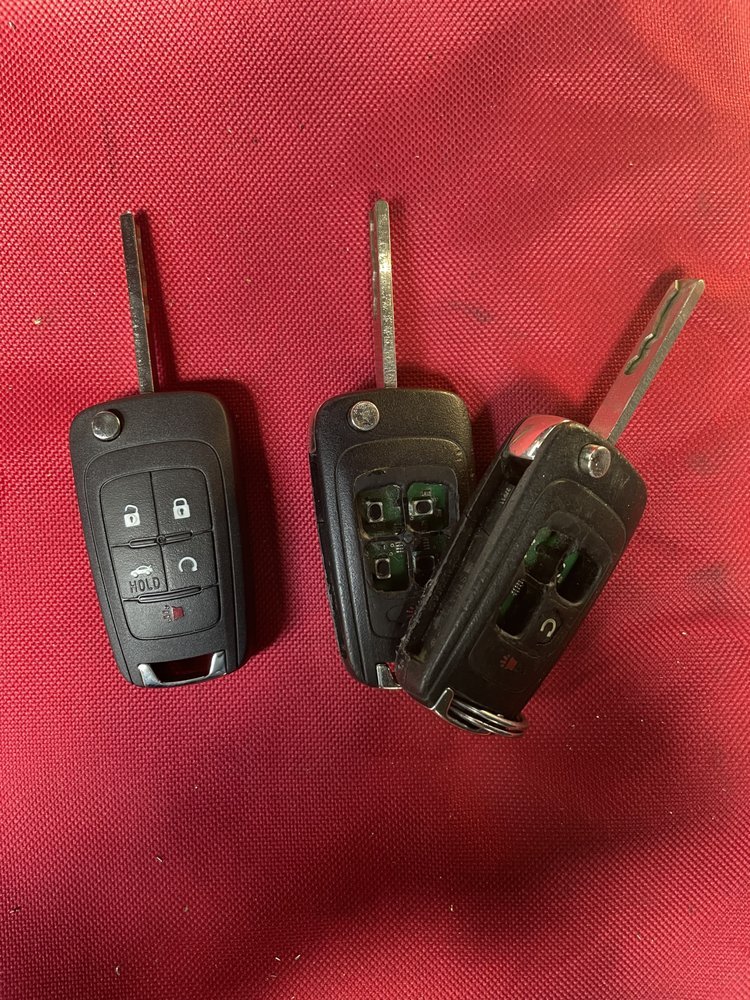 A new flip key next to two worn ones with their shells broken open